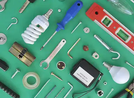 Various tools and hardware, ideal for any Property Owners Association, including a screwdriver, light bulbs, wrench, tape measure, level, cylinder lock, and screws, are arranged neatly on a green background.